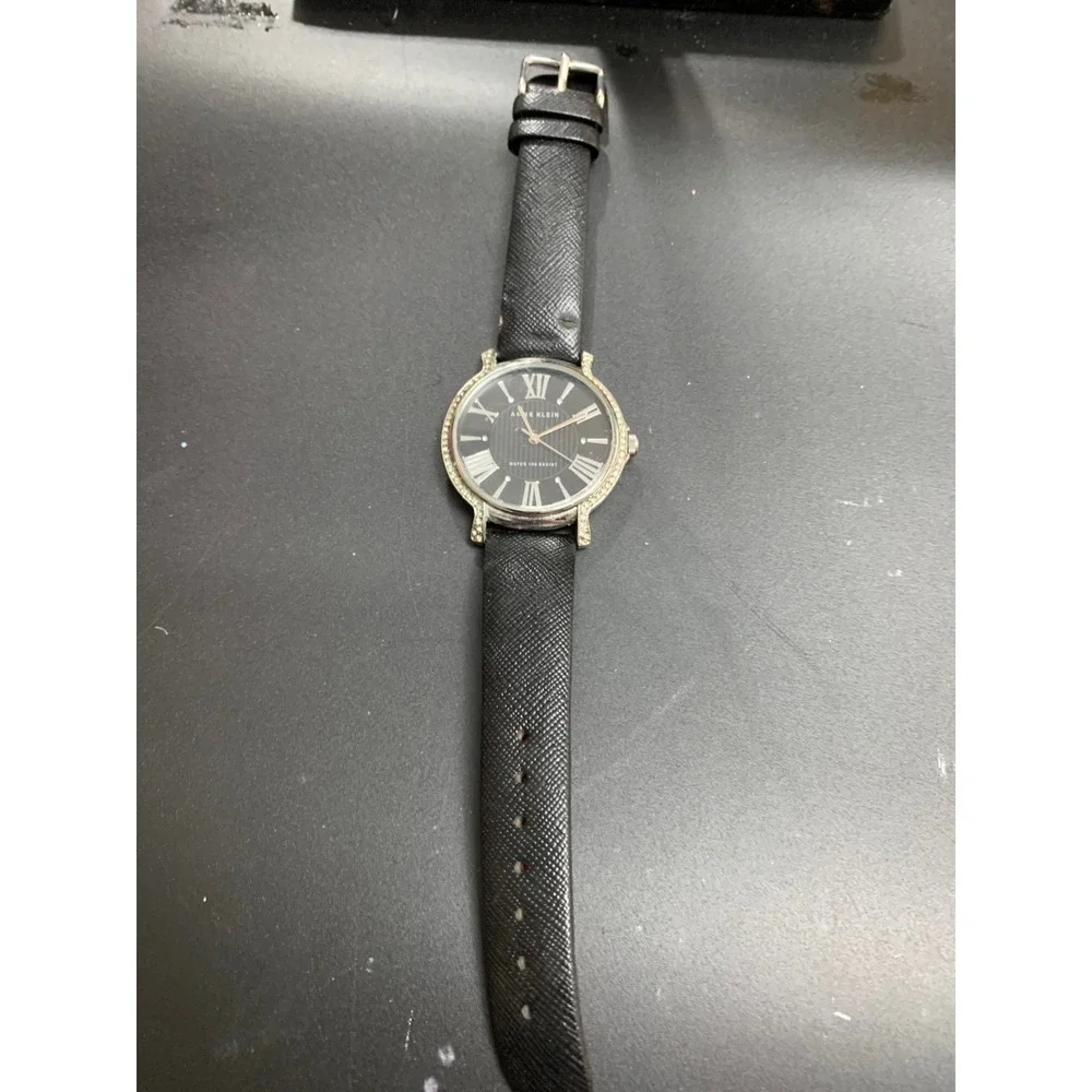 Anne Klein AK/1155 Crystal Bezel Black Dial Leather Strap Watch Womens